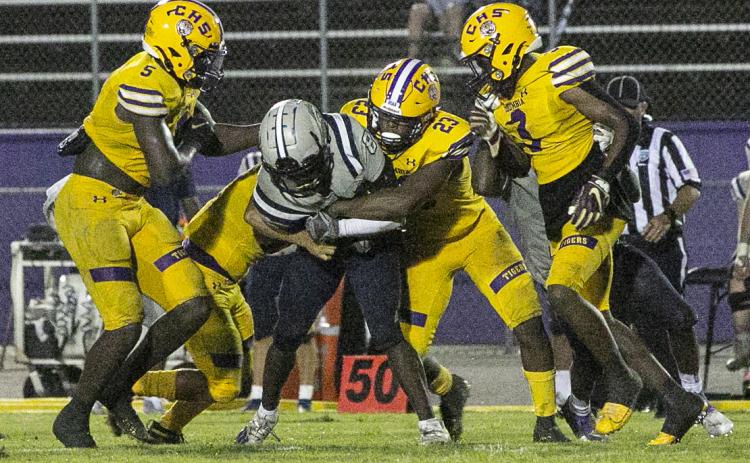Columbia linebacker Tyrell Peterson wraps up American Heritage-Delray receiver Brandyn Butler with help from teammates on Aug. 27. (JEN CHASTEEN/Special to the Reporter)