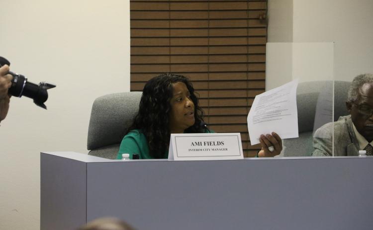 Lake City’s Interim City Manager Ami Fields reads off a list of her accomplishments in the two-plus months she has been in office at Tuesday’s City Council meeting as the council considered evaluating her performance. (MORGAN MCMULLEN/Lake City Reporter)