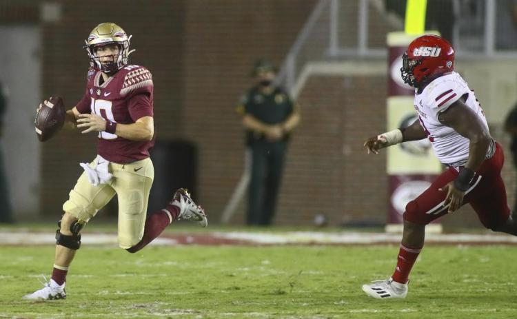 Florida State quarterback McKenzie Milton (10) scrambles out of the pocket as he is chased by Jacksonville State defensive end Umstead Sanders (12) on Sept. 11 in Tallahassee. Jacksonville State won 20-17. (PHIL SEARS/Associated Press)