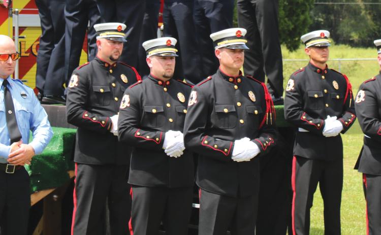 The Suwannee County Fire Rescue Honor Guard stands at attention at the funeral of former Chief Randy Burnham. (TONY BRITT/Lake City Reporter)
