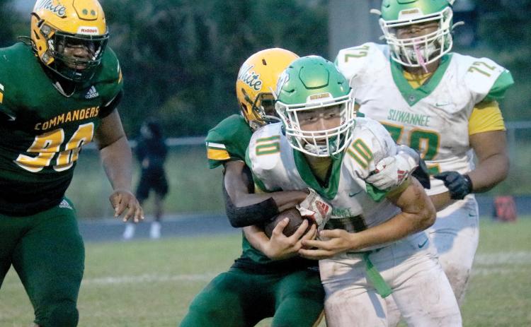 Suwannee quarterback Kodi Lang gets tackled by Ed White on Friday night. (JAMIE WACHTER/Lake City Reporter)