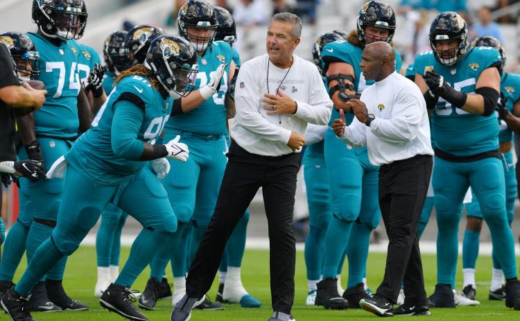 Jacksonville Jaguars head coach Urban Meyer and assistant head coach Charlie Strong get their players motivated before the start of Sunday's game against the Tennessee Titans in Jacksonville. (BOB SELF/Florida Times-Union/TNS)