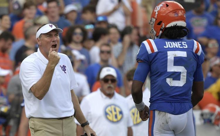 Florida head coach Dan Mullen, left, calls out instructions in front of quarterback Emory Jones (5) during a game against Vanderbilt on Oct. 9 in Gainesville. (AP Photo/PHELAN M. EBENHACK/Associated Press)