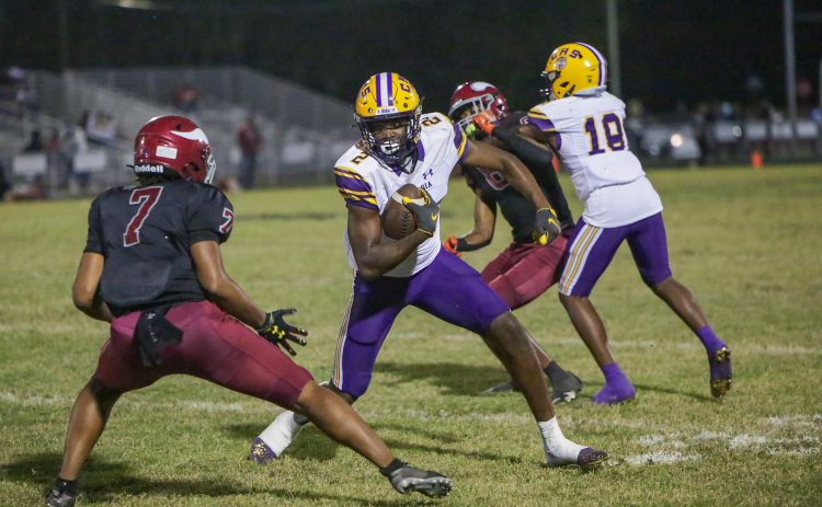 Columbia receiver Marcus Peterson looks to make move past Raines defensive back Kyree Hammond on Thursday. (BRENT KUYKENDALL/Lake City Reporter)