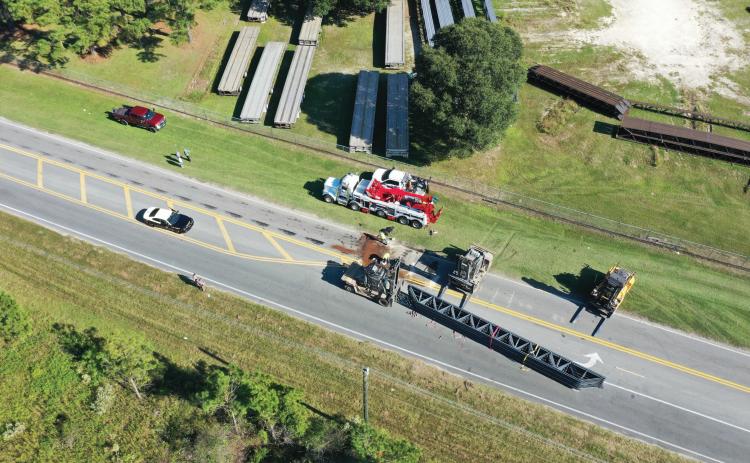 A full load of overturned building trusses shut down a portion of Bascom Norris Drive on Friday afternoon after the load shifted on the trailer coming out of a turn. (RAY CARPENTER/Special to the Reporter)