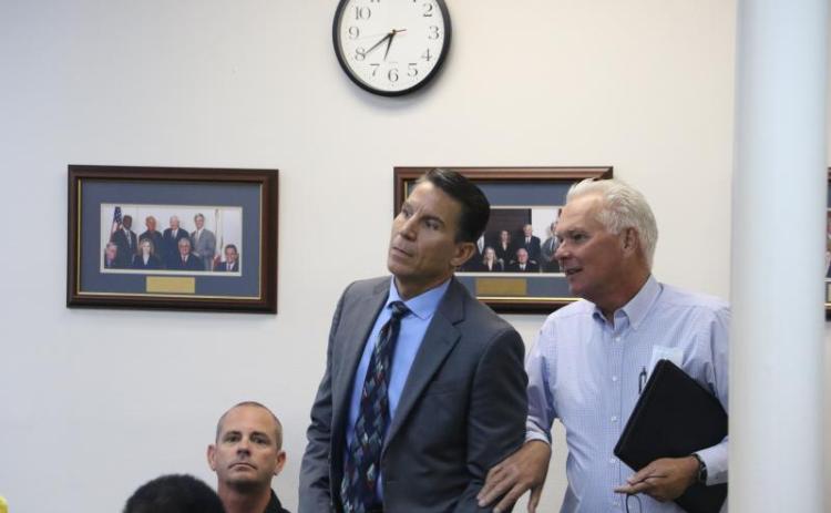 Stephen A. Douglas (left) reacts to being chosen for the District 14 seat at an Oct. 13 meeting. (FILE)