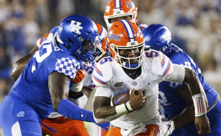 Florida quarterback Emory Jones (5) runs the ball upfield against Kentucky on Oct. 2 in Lexington, Ky. (MICHAEL CLUBB/Associated Press)