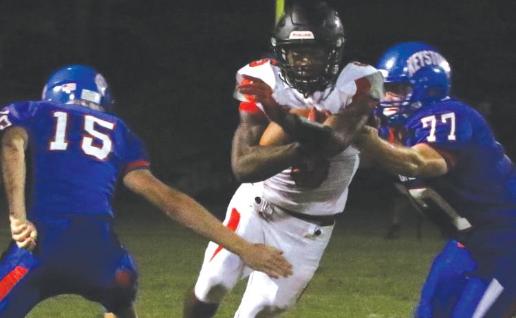 Fort White running back Darren Clark runs past Keystone Heights defensive lineman Trey Jeffries on Oct. 1. (MORGAN MCMULLEN/Lake City Reporter)
