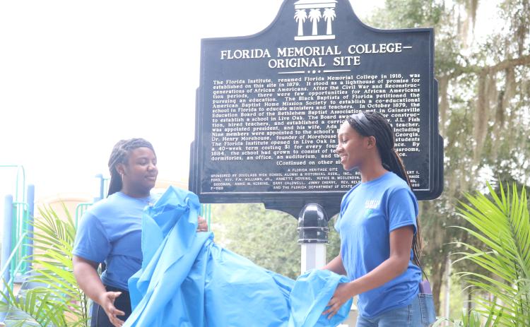 Members of the D.E.V.O.T.E.D 4-H Club unveil the historical marker at the original site of Florida Memorial University in Live Oak on Saturday. (JAMIE WACHTER/Lake City Reporter)