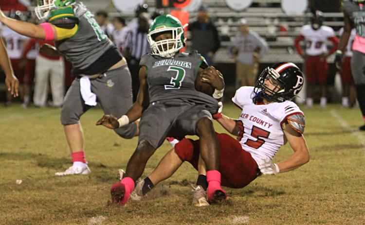 Suwannee running back Malachi Graham is tackled from behind by a Baker County defender on Friday. (PAUL BUCHANAN/Special to the Reporter)