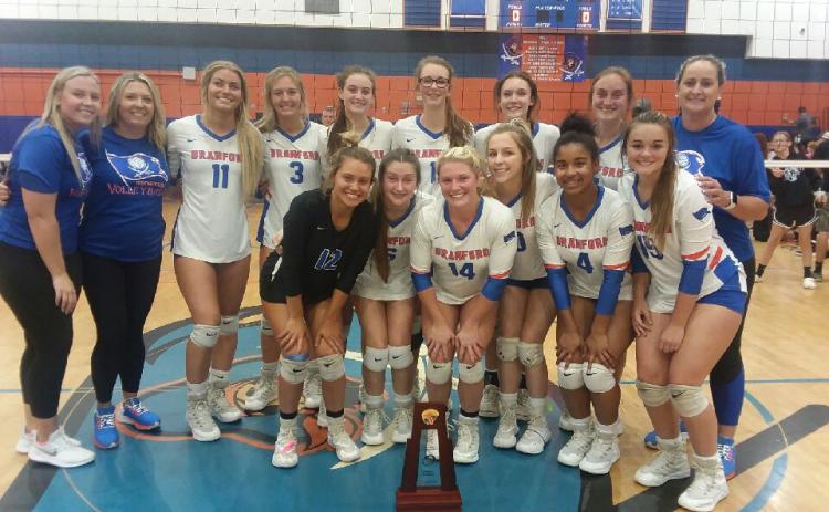 Branford’s volleyball team poses with the District 5-1A championship trophy after defeating Lafayette in five sets Thursday night. (CONCEPCION LEDEZMA/Special to the Reporter)
