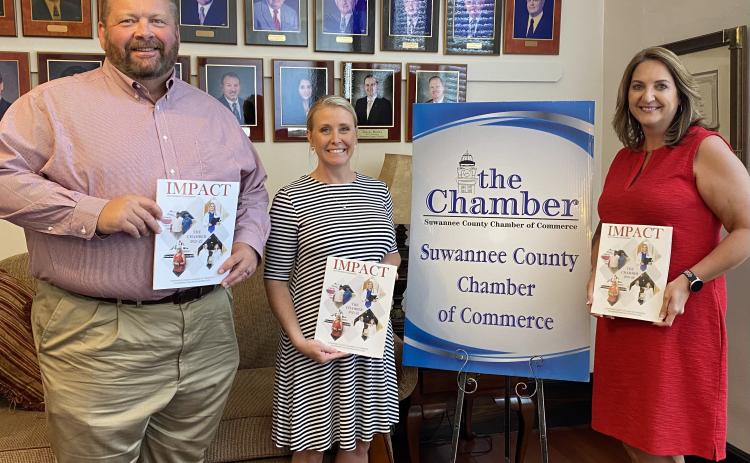 Hillary Cannon, center, executive director of the Suwannee County Chamber of Commerce stands with Lake City Reporter Publisher Todd Wilson, left, and Monja Slater, Lake City Reporter business development manager, during the unveiling of the Chamber’s 2021-2022 ‘Impact’ magazine this week. The Reporter partnered with the Suwannee Chamber to produce the annual magazine. (COURTESY)