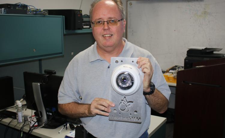 Shayne Morgan, Columbia County Emergency Management director, holds a WeatherSTEM monitor that was struck by lightning earlier this year. (TONY BRITT/Lake City Reporter)