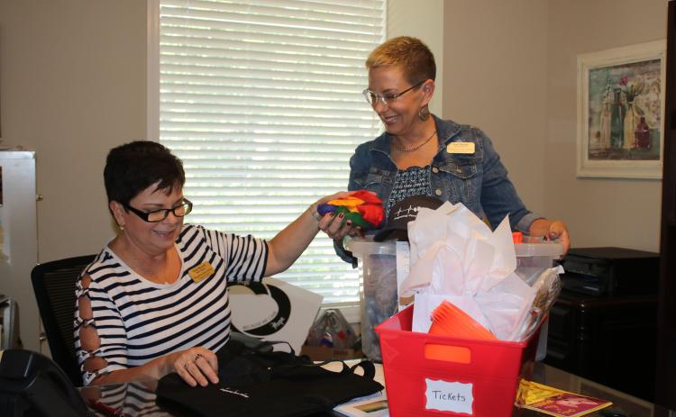Vicki Morrell (from left), Pregnancy Care Center administrative assistant and Lori North, Pregnancy Care Center Executive Director, pack materials as they prepare for Saturday’s Pregnancy Care Center 5K Walk/Run 4 Life. (TONY BRITT/Lake City Reporter)