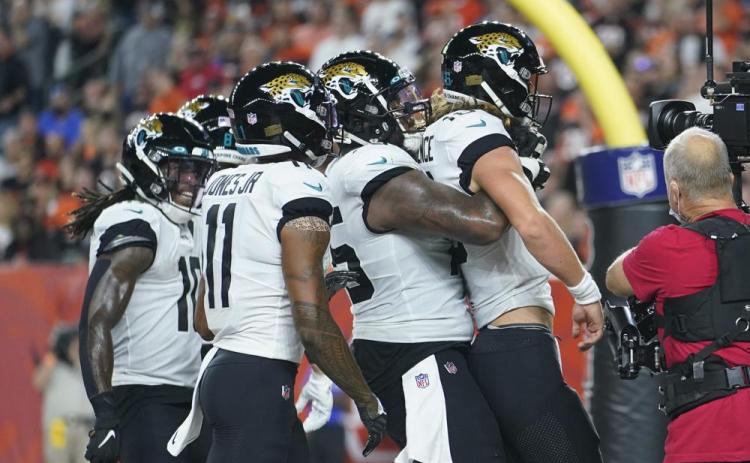 Jacksonville Jaguars quarterback Trevor Lawrence, front, celebrates with teammates after rushing for a touchdown against the Cincinnati Bengals on Sept. 30 in Cincinnati. (MICHAEL CONROY/Associated Press)