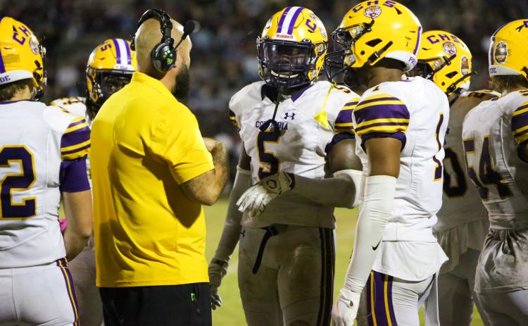 Columbia safety/linebacker Jaden Robinson (5) and cornerback Amare Ferrell (1) speak to co-defensive coordinator John Woodley during last Friday's game against Madison County. (BRENT KUYKENDALL/Lake City Reporter)