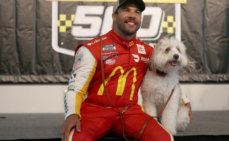 Bubba Wallace celebrates in victory lane with his dog Asher after winning the rain-shortened NASCAR Cup Series YellaWood 500 at Talladega Superspeedway on Monday in Talladega, Ala. (CHRIS GRAYTHEN/Getty Images/TNS)