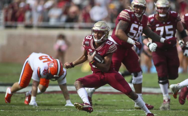 Florida State quarterback Jordan Travis (13) makes a cut for a long run against Syracuse on Oct. 2 in Tallahassee, (PHIL SWARS/Associated Press)