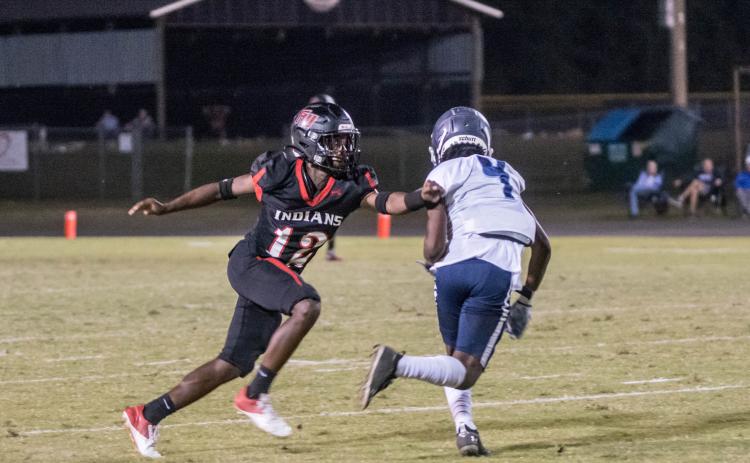 Fort White defensive back Najeeb Smith, bumping a PK Yonge receiver at the line of scrimmage, had two interceptions, including a pick-6. (CHRISTINA FEAGIN/Special to the Reporter)
