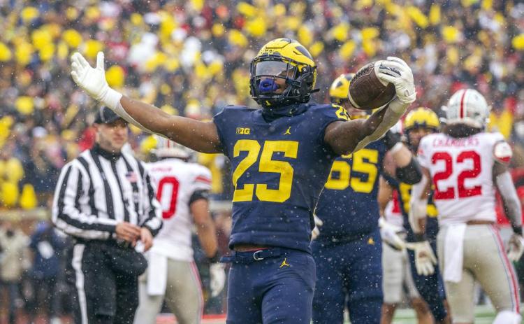 Michigan running back Hassan Haskins (25) celebrates a touchdown against Ohio State on Saturday in Ann Arbor, Mich. Michigan won 42-27. (TONY DING/Associated Press)