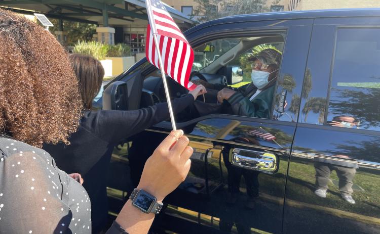 A military veteran receives gifts during a drive-through event at the Lake City VA Medical Center on Monday morning. (COURTESY)