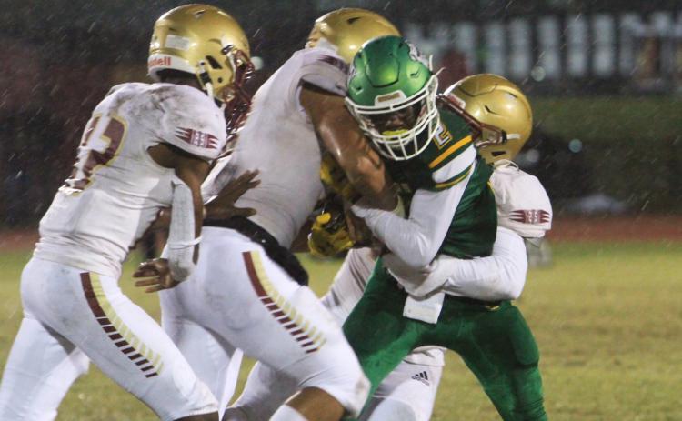 Suwannee receiver Jay Smith is tackled by a host of Florida High defenders on Friday night. (PAUL BUCHANAN/Special to the Reporter)