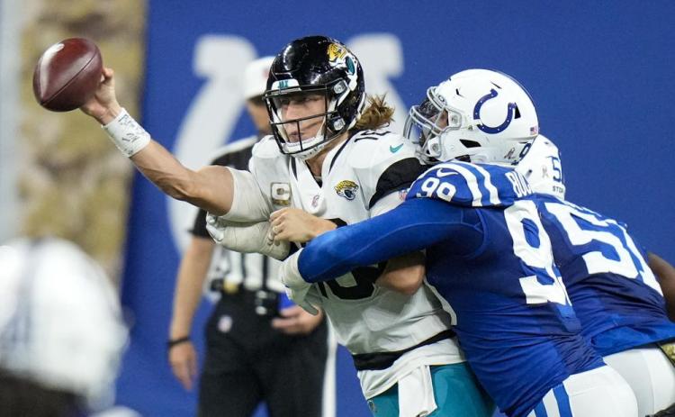 Jacksonville Jaguars quarterback Trevor Lawrence is hit by Indianapolis Colts defensive tackle DeForest Buckner during Sunday’s game in Indianapolis. (AJ MAST/Associated Press)