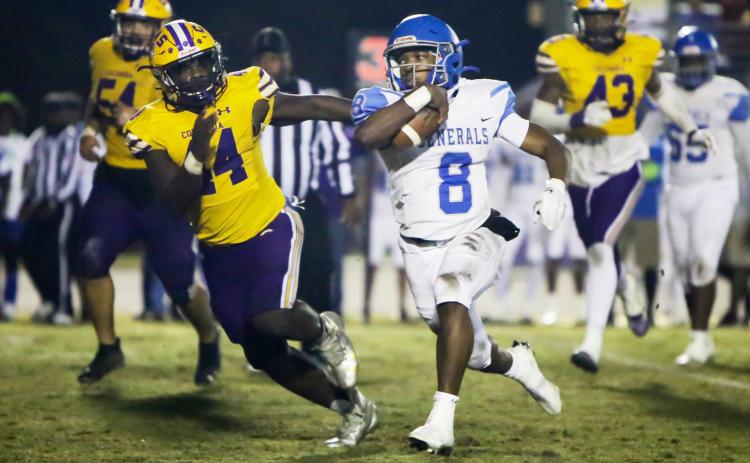 Columbia defensive end Bobby Miller chases after Riverside quarterback Cale Zarah during Friday’s Region 1-6A quarterfinal. (BRENT KUYKENDALL/Lake City Reporter)
