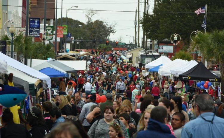 A crowd attends a previous year’s Christmas on the Square festival in Live Oak. The festival returns for the 37th year, starting Thursday and running through Dec. 4. (FILE)