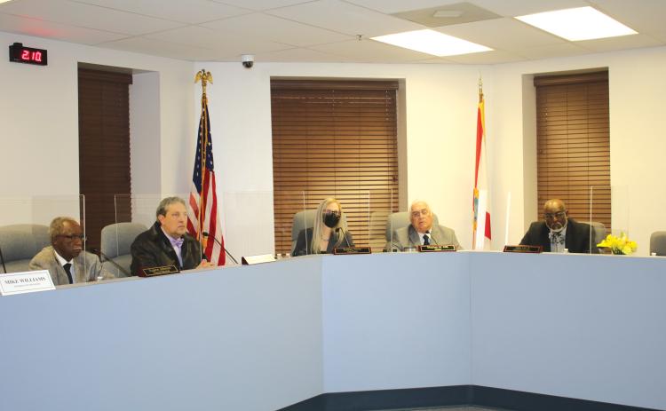 Council Members Eugene Jefferson (from left) and Todd Sampson, City Clerk Audrey Sikes, Mayor Stephen Witt and Council Member Jake Hill Jr. listen to a speaker at Monday’s city council meeting. (TONY BRITT/Lake City Reporter)
