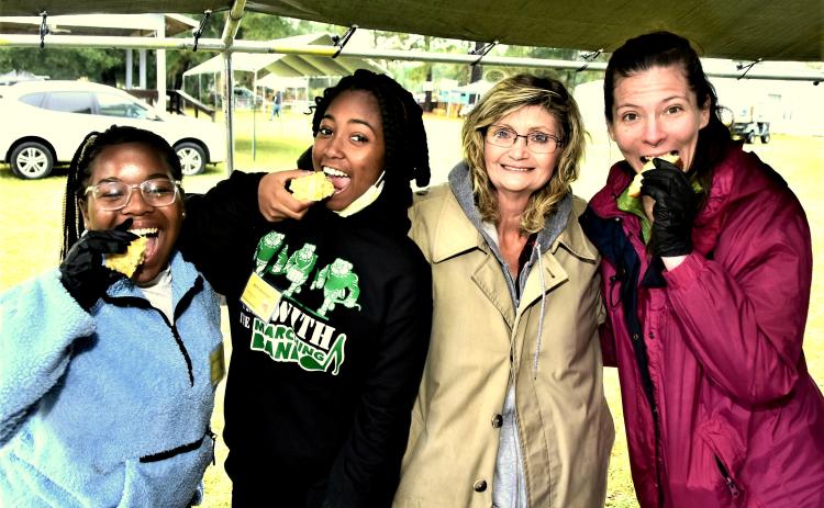 Attendees of the inaugural Wellborn Cornbread Festival take a bite from some local entries to the event. (ROB WOLFE/Special to the Reporter)