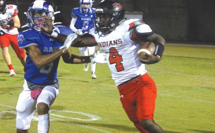 Fort White running back Maliki Clark stiff arms an Interlachen defender on Oct. 29. (MORGAN MCMULLEN/Lake City Reporter)
