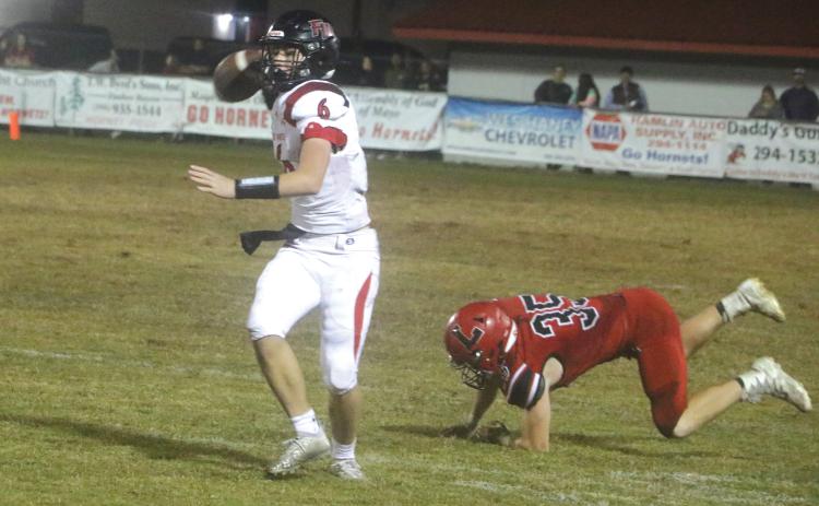Fort White quarterback Clayton Philpot rolls out to pass against Lafayette during Friday’s Region 3-1A quarterfinal. (MORGAN MCMULLEN/Lake City Reporter)