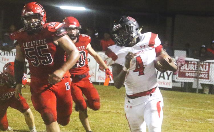 Fort White running back Maliki Clark rushes up the field against Lafayette during Friday’s Region 3-1A quarterfinal. (MORGAN MCMULLEN/Lake City Reporter)