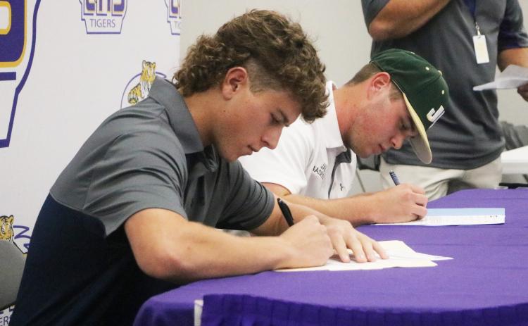 Columbia baseball players Truitt Todd (left) and Brent Howard (right) sign their letters of intent on Wednesday. Todd signed with Florida State College at Jacksonville and Howard signed with Jacksonville. (JORDAN KROEGER/Lake City Reporter)