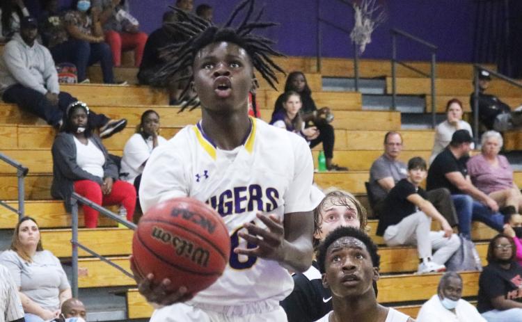 Columbia guard Isaac Broxey rises to shoot against Hawthorne last season. (FILE)
