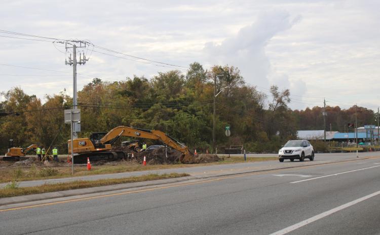 A construction crew works on digging ground for a new roundabout near Bascom Norris Drive. (TONY BRITT/Lake City Reporter)