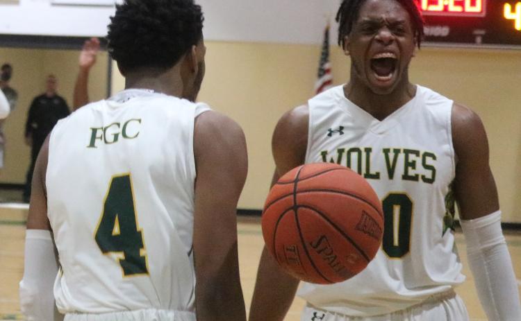 Florida Gateway College forward Omari Jordan yells in celebration after guard Antonio Card (4) scores against Pasco-Hernando-State College on March 4. (JORDAN KROEGER/Lake City Reporter)