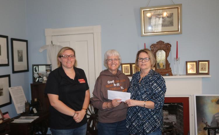 Rose Pavey (middle), the trustee from the Aloysius (Al) Harter trust, donates $25,000 to the Lake City-Columbia County Historical Museum. Accepting the donation for the museum are Kim Estergren (right), the museum president, and Shelly Fuller. (JAMIE WACHTER/Lake City Reporter)