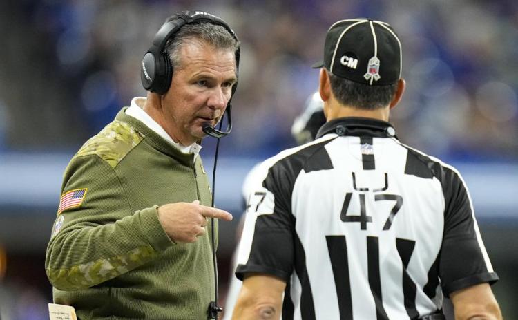 Jacksonville Jaguars head coach Urban Meyer talks with line judge Tim Podraza during Sunday's game against the Indianapolis Colts in Indianapolis. (AJ MAST/Associated Press)