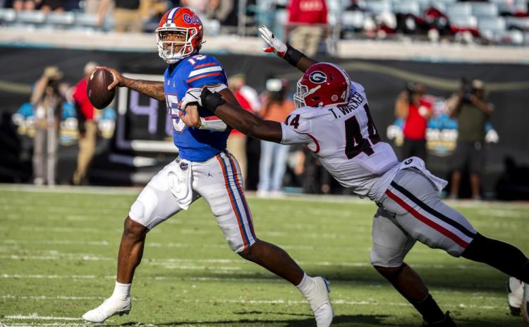 Florida quarterback Anthony Richardson scrabbles out of the pocket while being chased by Georgia defensive lineman Travon Walker (44) on Oct. 30 in Jacksonville. (STEPHEN B. MORTON/Atlanta Journal-Constitution via AP)