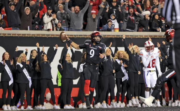 Cincinnati quarterback Desmond Ridder celebrates after catching a touchdown pass against SMU on Saturday in Cincinnati. Cincinnati won 48-14. (AARON DOSTER/Associated Press)
