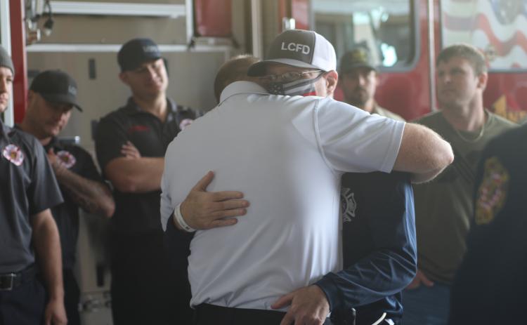 Lake City Fire Department Lt. Jeff McNeill hugs a fellow firefighter Wednesday afternoon at the Lake City Fire Station. McNeill was returning home from rehab in Jacksonville following a lengthy battle and recovery from covid-19. (JAMIE WACHTER/Lake City Reporter)