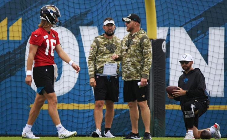 Jacksonville Jaguars interim head coach Darrell Bevell, an offensive coordinator under former coach Urban Meyer, leads practice while talking with quarterback Trevor Lawrence on Dec. 16 at TIAA Bank Field's practice field in Jacksonville. (COREY PERRINE/The Florida Times-Union via AP)