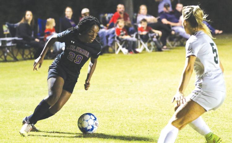 Columbia’s Olivia Kelly takes on Suwannee’s Hannah Humphries inside the penalty box during Friday night’s match. (MORGAN MCMULLEN/Lake City Reporter)