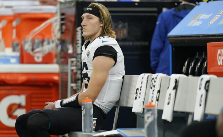 Jacksonville Jaguars quarterback Trevor Lawrence sits on the bench in the closing minutes of Sunday's loss to the Los Angeles Rams in Inglewood, Calif. (JAE C. HONG/Associated Press)