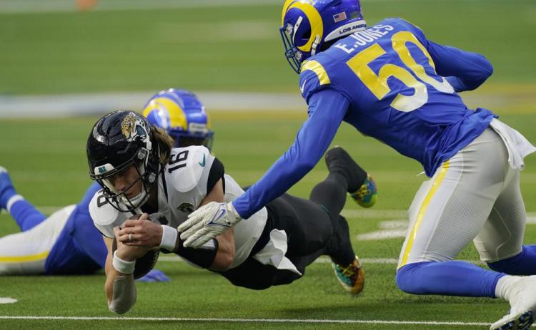 Jacksonville Jaguars quarterback Trevor Lawrence lunges for yardage against the Los Angeles Rams on Dec. 5 in Inglewood, Calif. (MARK J. TERRILL/Associated Press)