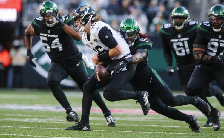 New York Jets linebacker C.J. Mosley strip sacks Jacksonville Jaguars quarterback Trevor Lawrence during Sunday's game in East Rutherford, N.J. (JOHN MUNSON/Associated Press)