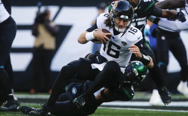 New York Jets cornerback Jason Pinnock tackles Jacksonville Jaguars quarterback Trevor Lawrence on Dec. 26 in East Rutherford, N.J. (JOHN MUNSON/Associated Press)