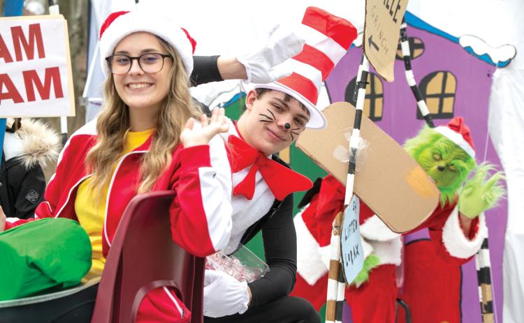 The Cat in the Hat and Grinch wave from a float during last year’s Fort White Business Council Christmas parade. This year’s parade is scheduled for Saturday at noon. (JEN CHASTEEN/Special to the Reporter)